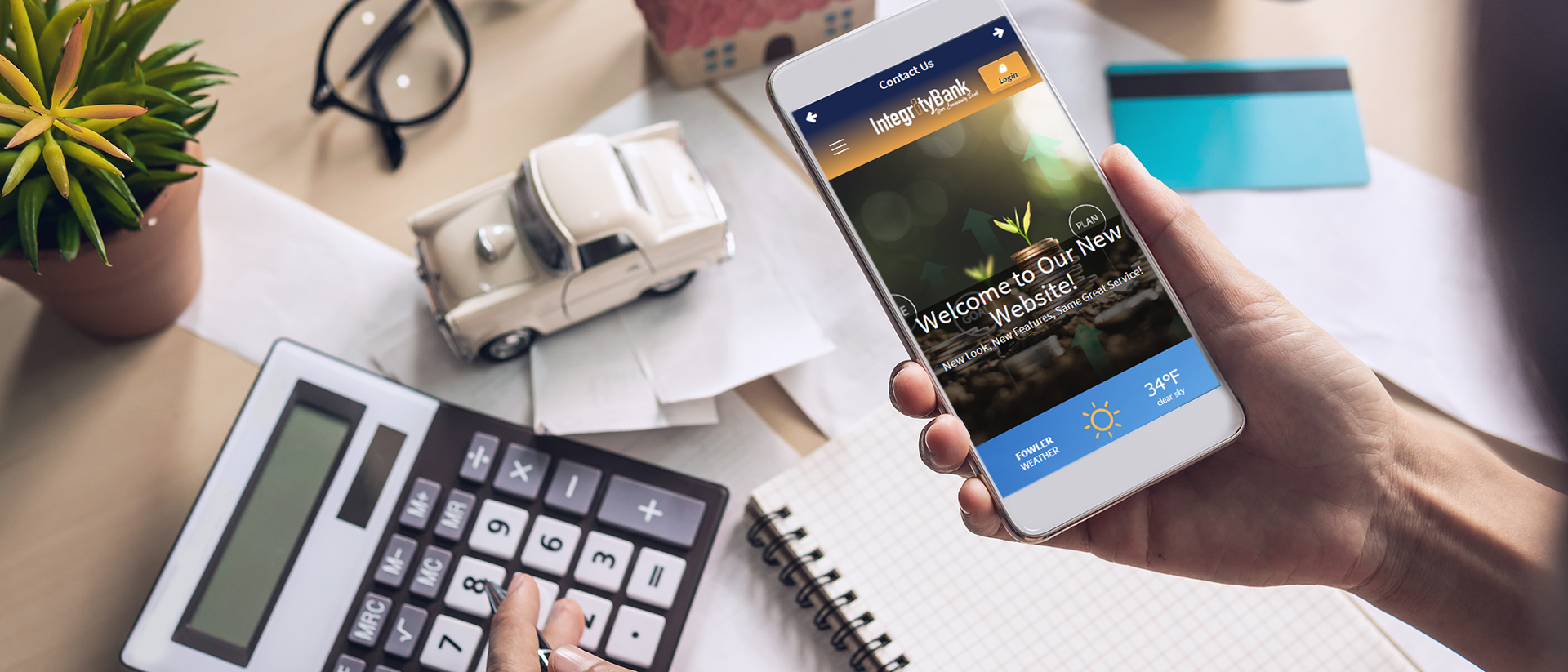 woman holding cellphone and working with a calculator